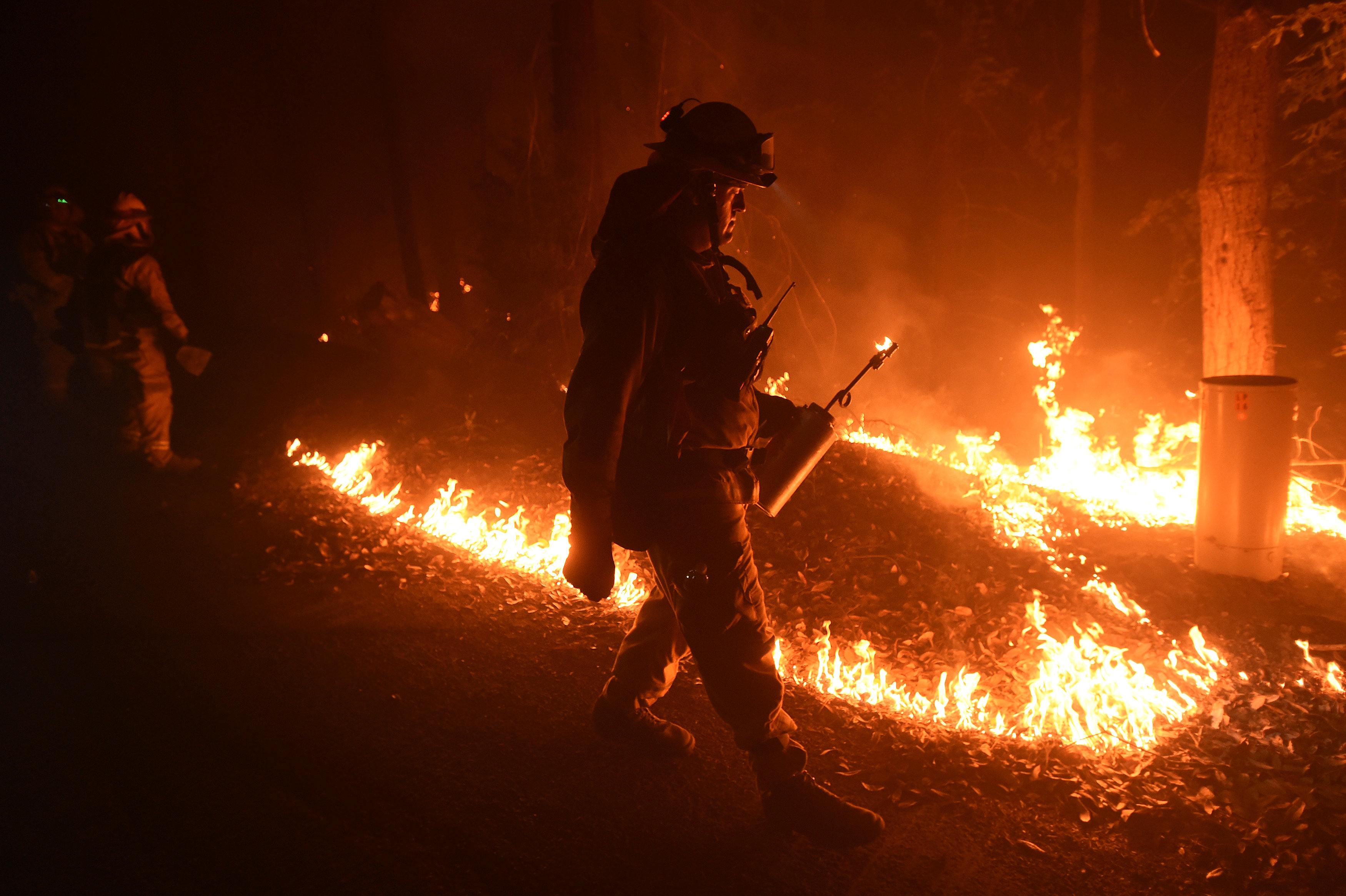 Firefighters battle California wildfires, bulldozer operator dies