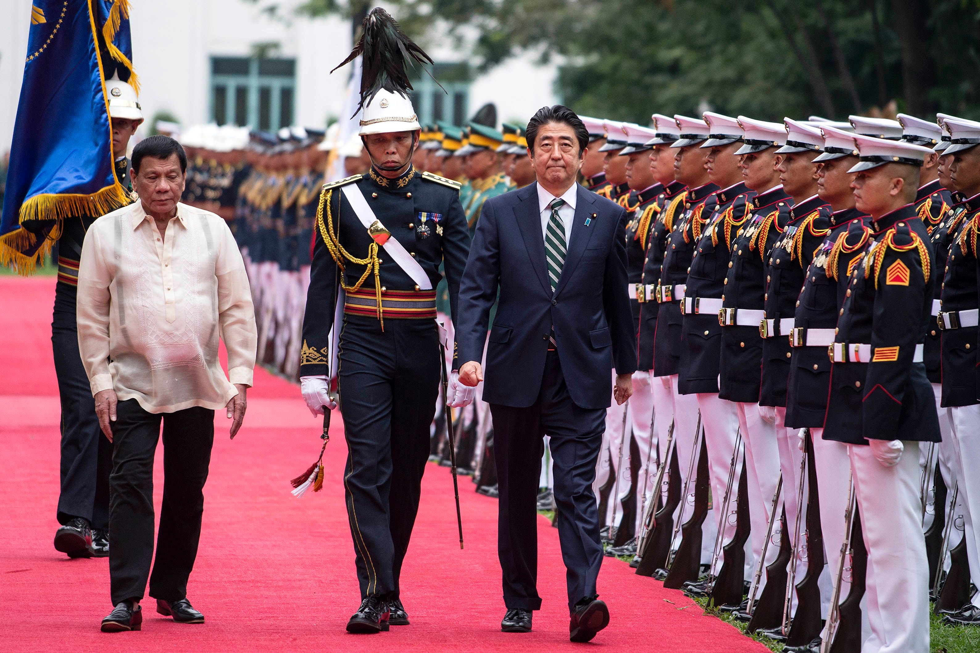 Japan's Abe visits Philippines as Duterte's first top guest