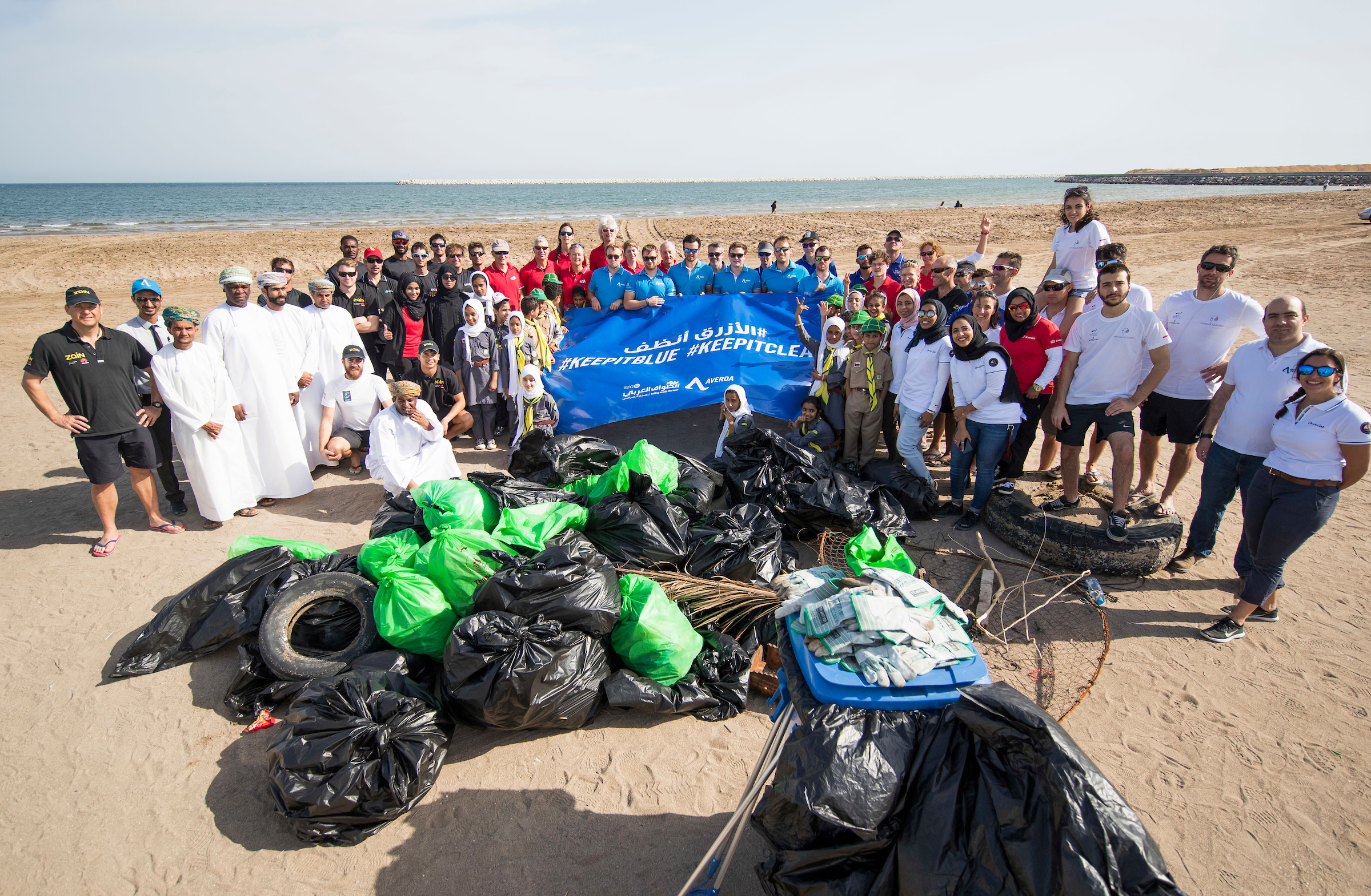 Oman Sail stress environmental care as sailing crews clean up Al Hail Beach