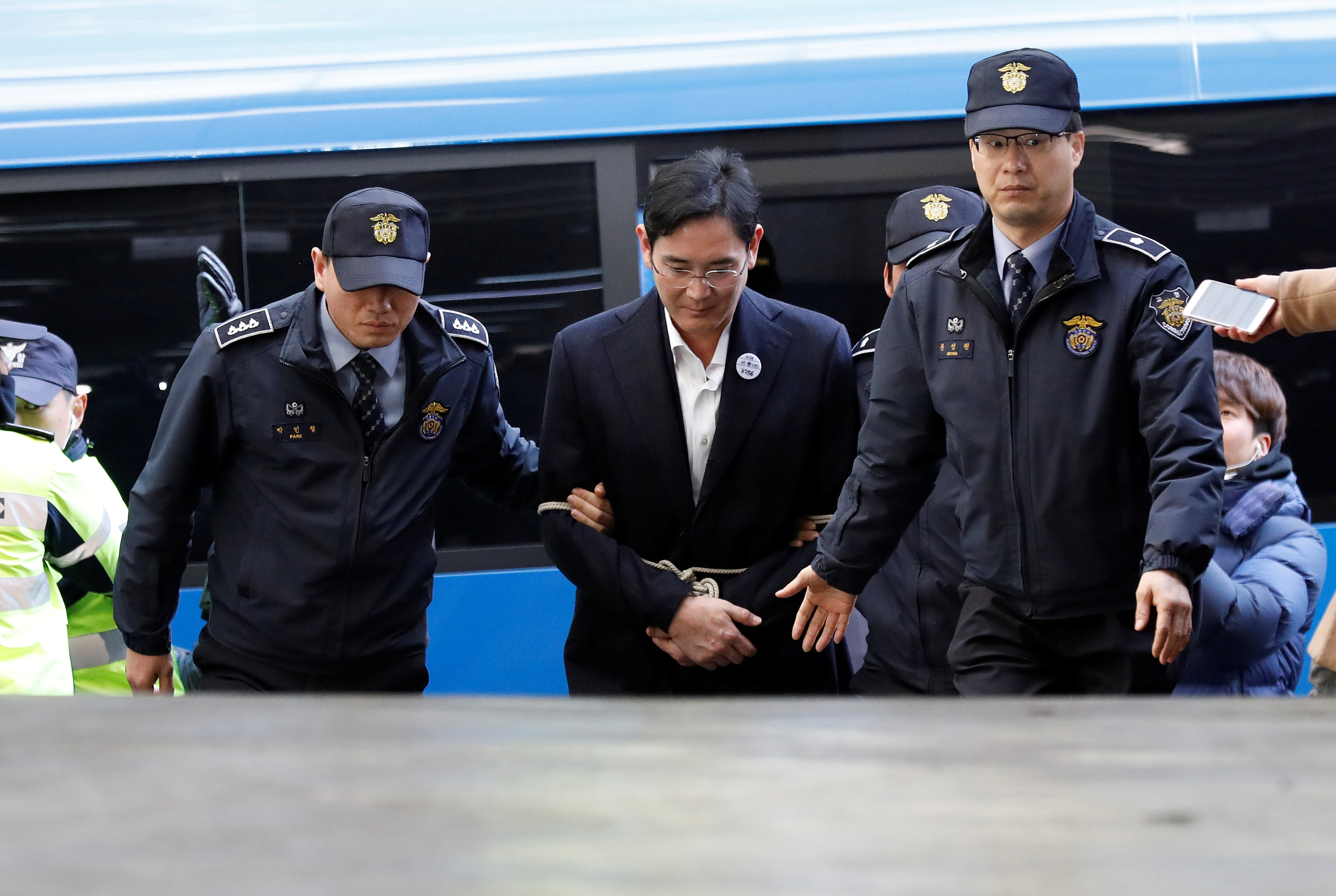 Samsung scion taken for questioning after night in cell