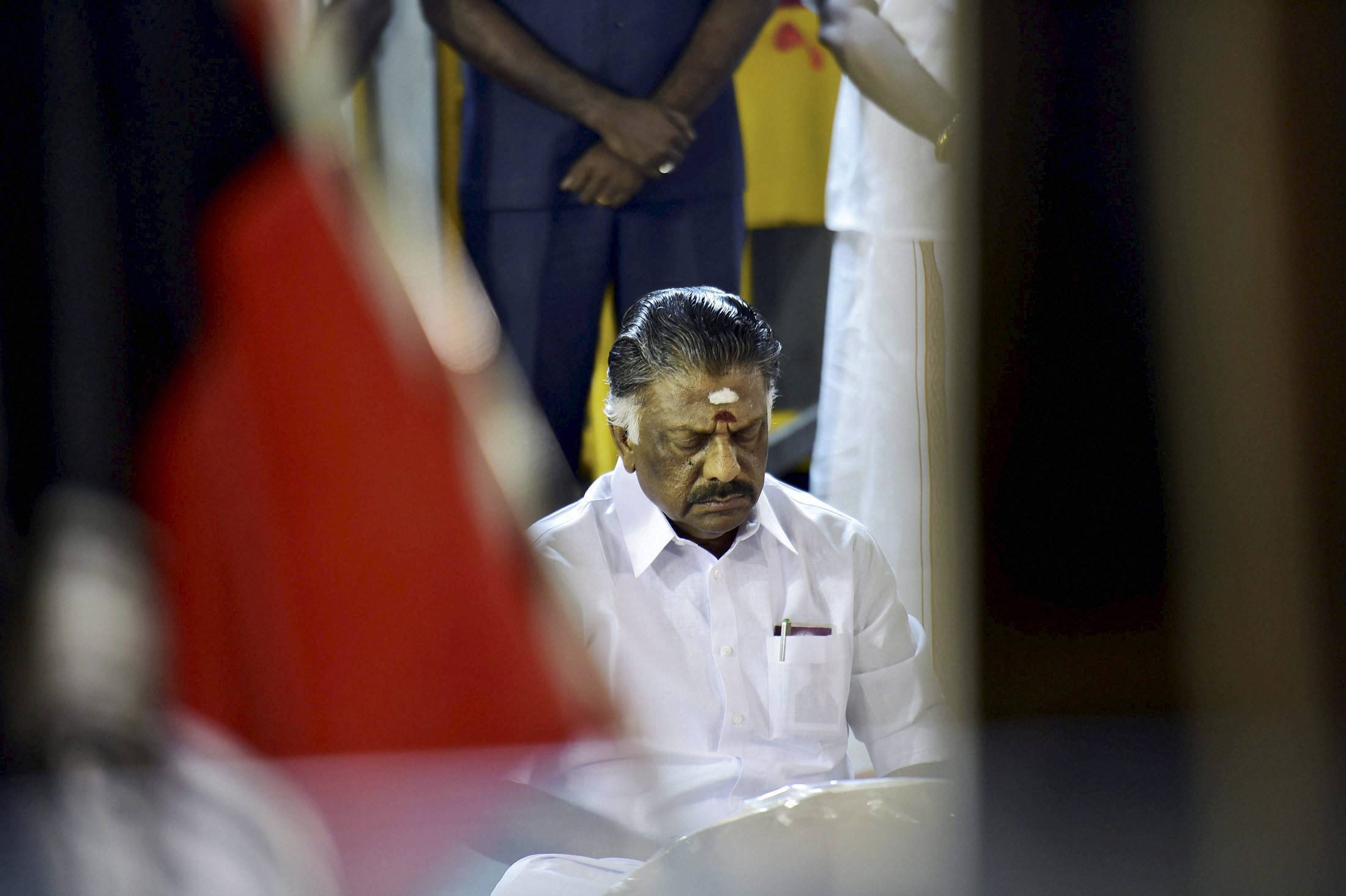 Panneerselvam sits alone in meditation at Jaya's burial site
