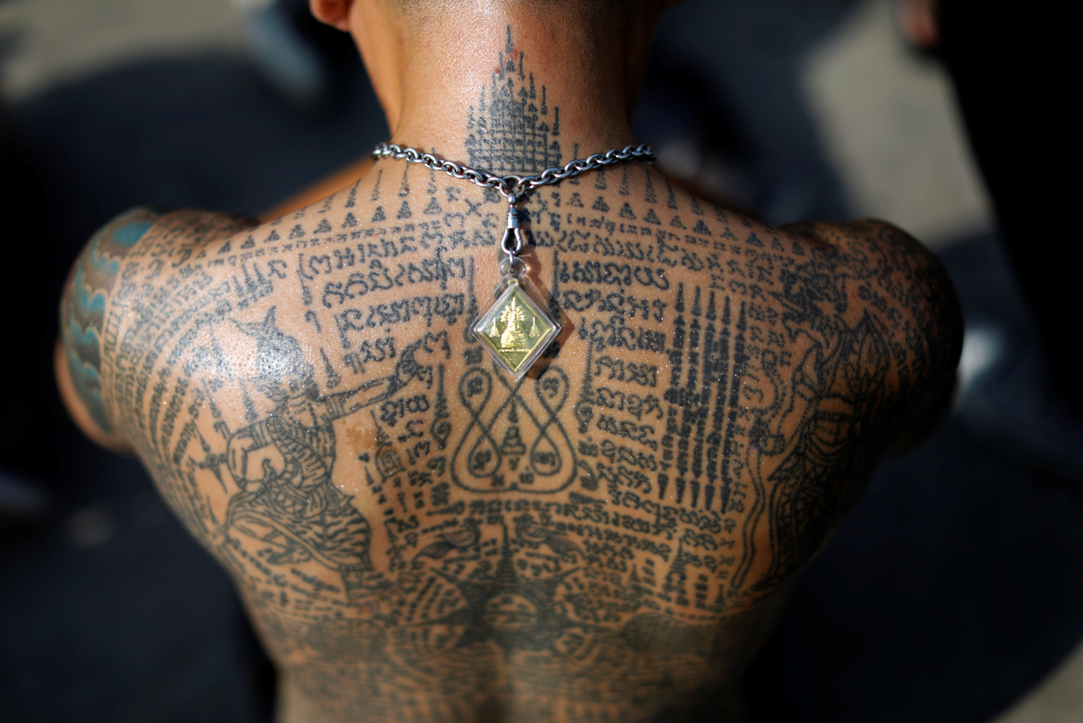 Tattooed devotees transform in Thai temple trance