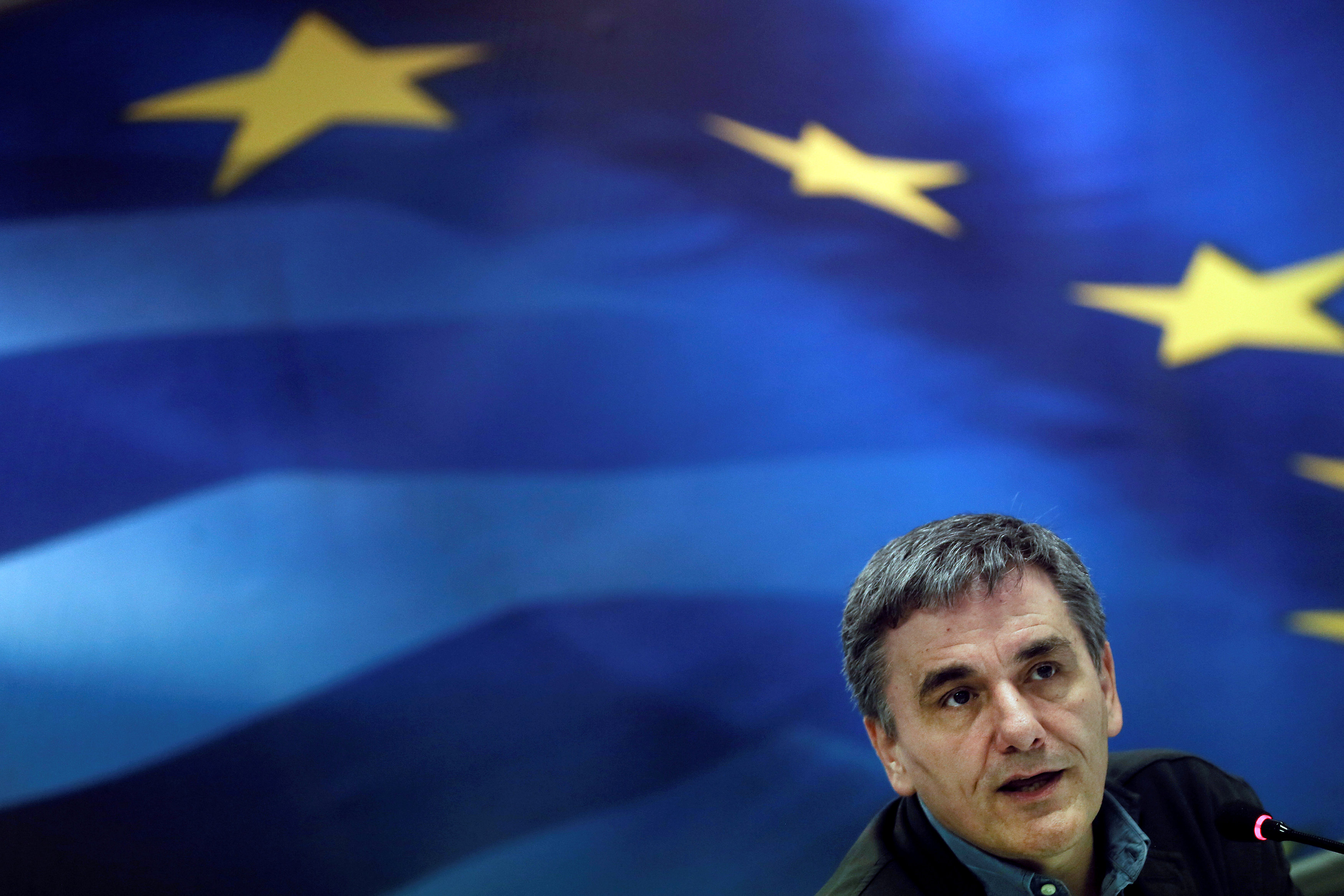 Pledging more austerity, Greece cuts deal with lenders