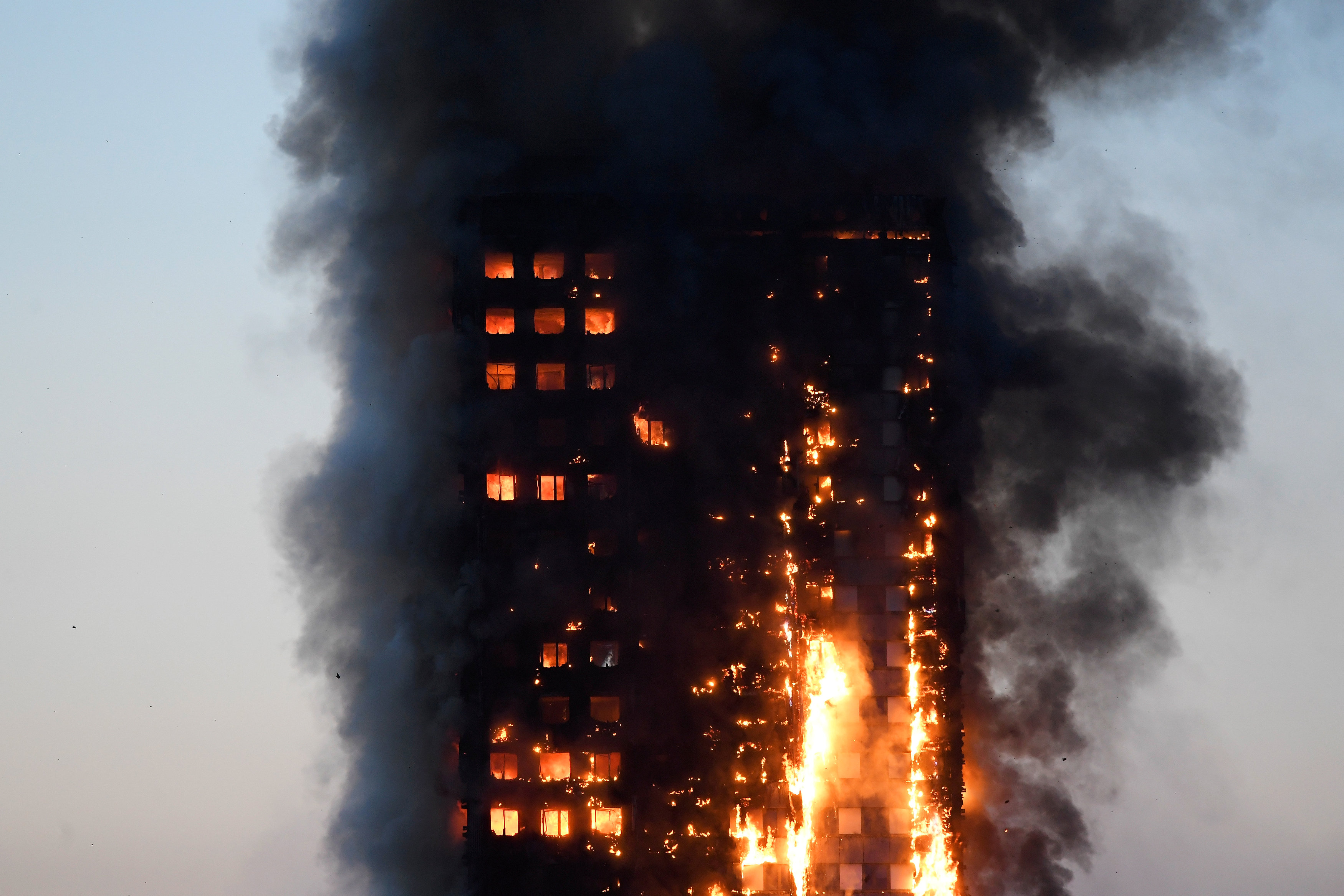 Fire engulfs London tower block, at least 12 dead, dozens injured