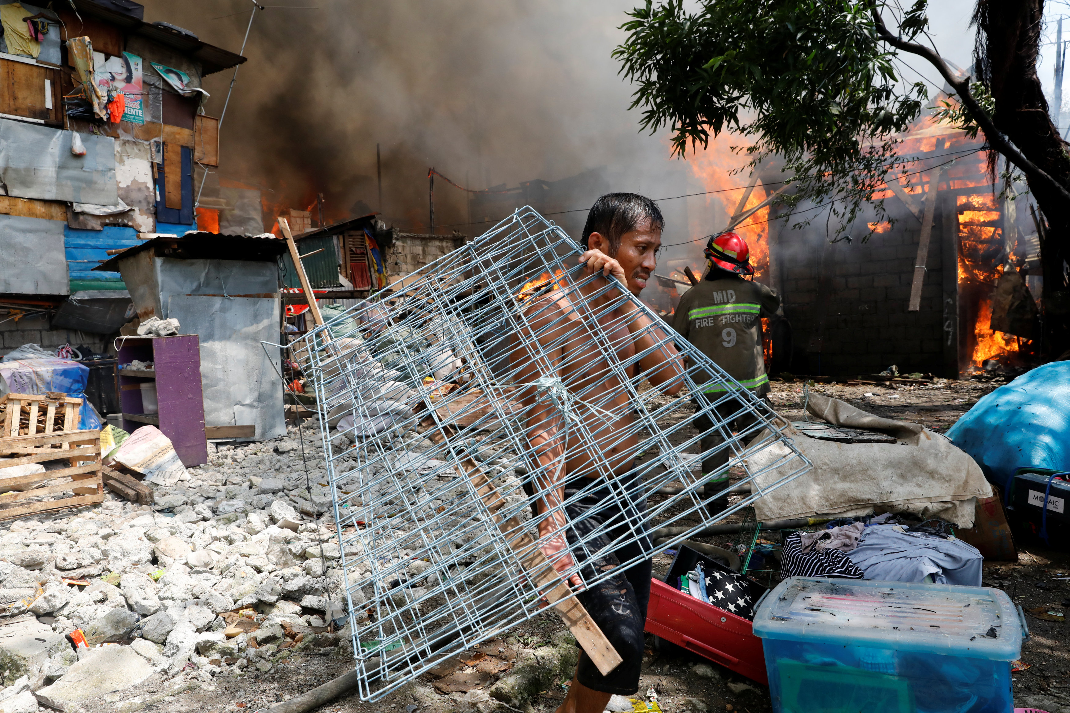 In pictures: Fire engulfs residential area in the Philippines