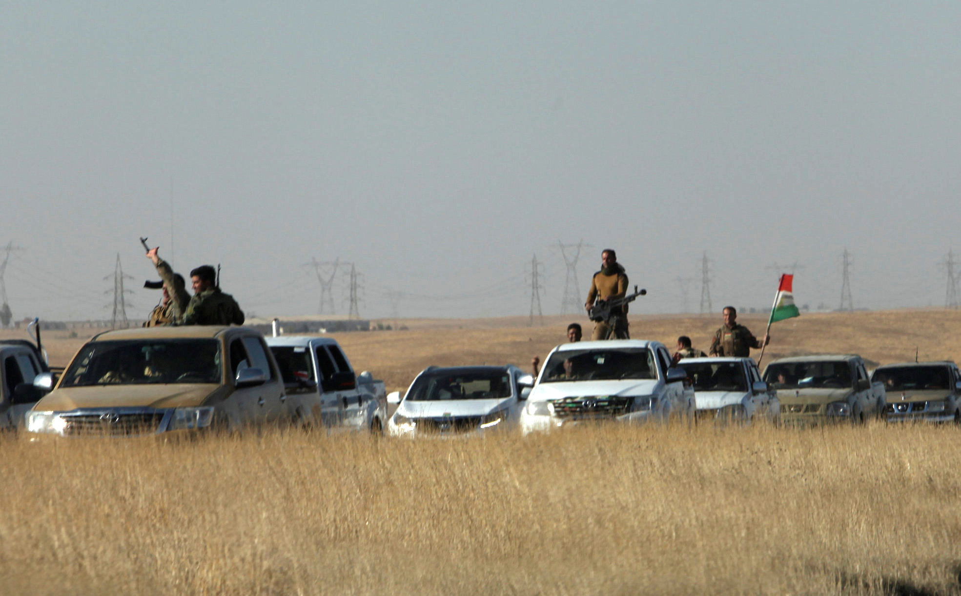 Iraq paramilitaries battle Kurds in push towards Turkish border oil hub