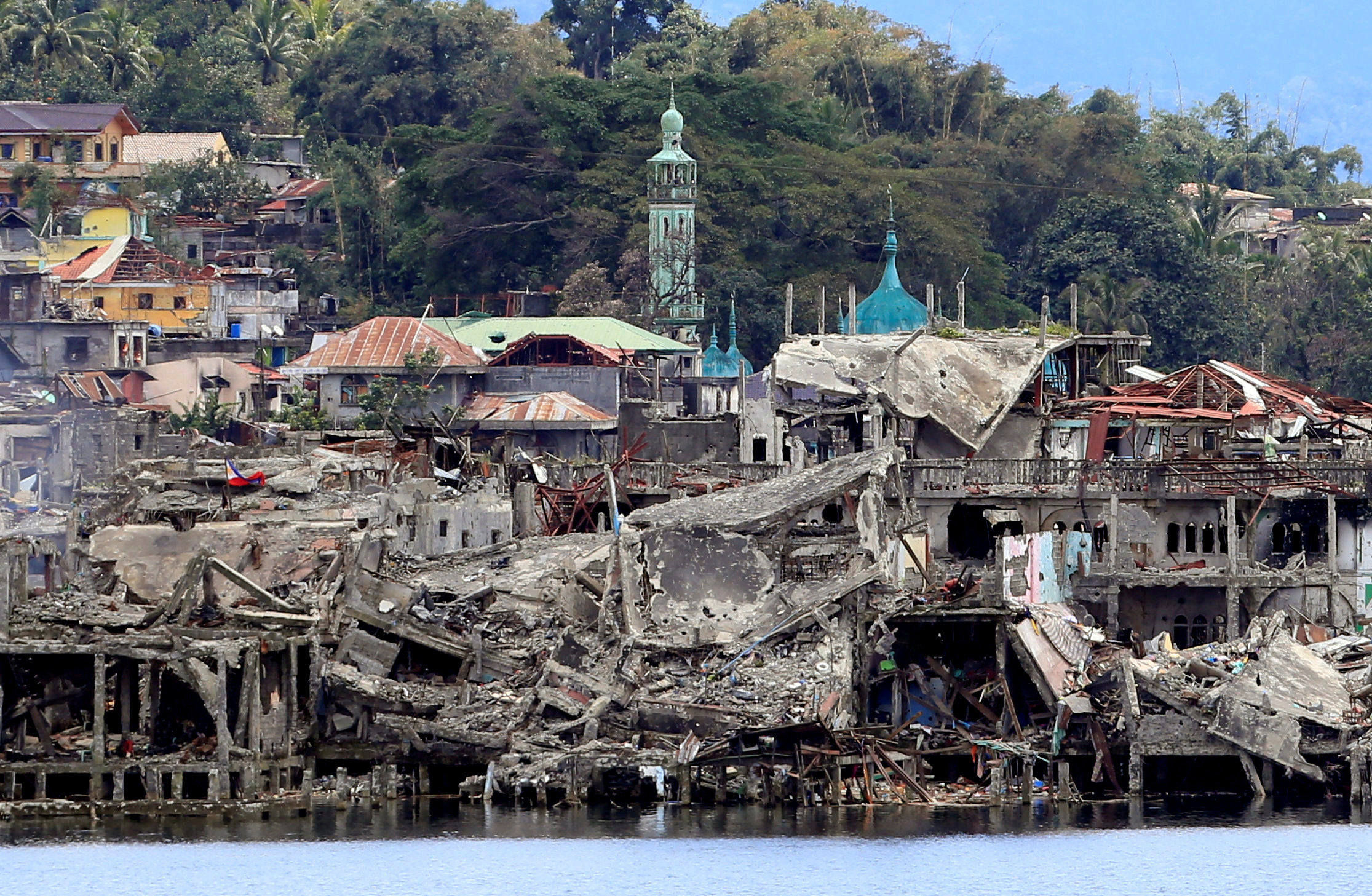 Families returning to ruined Philippines' Marawi City taught to identify bombs