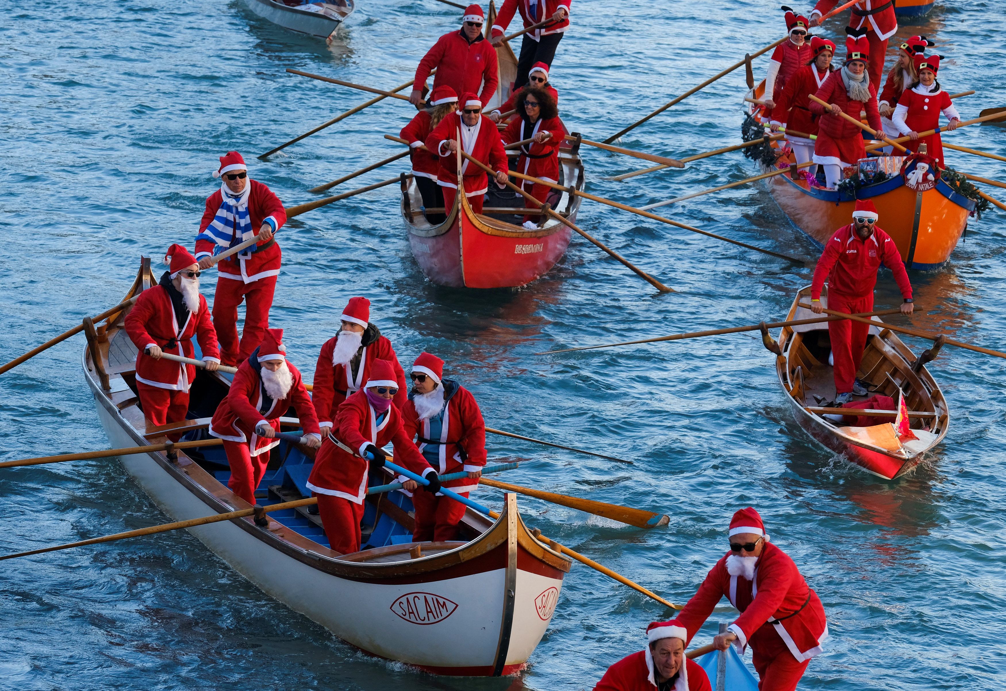 In pictures: Santas on boats in Venice