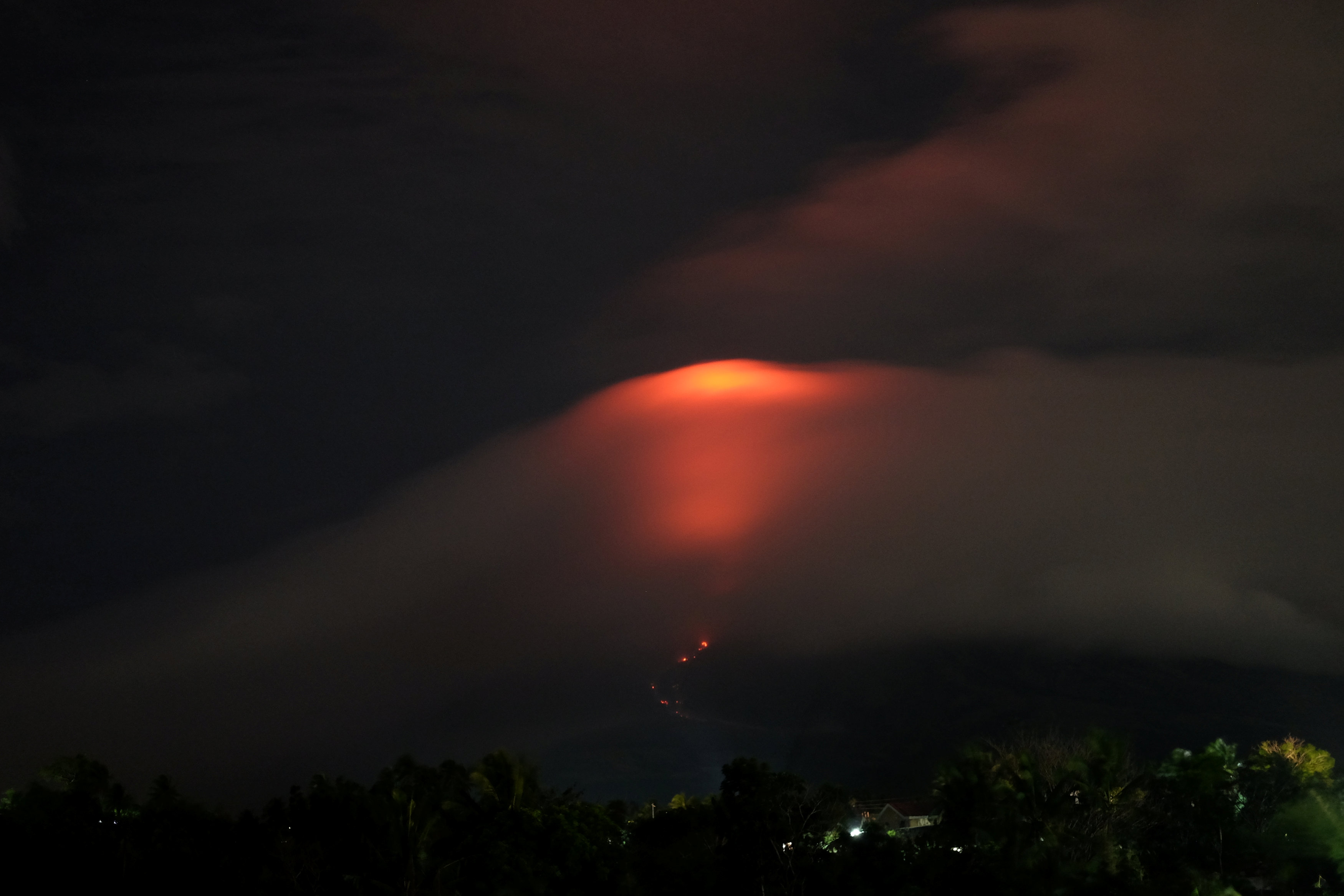 Philippines orders forced evacuation as lava spreads around restive volcano