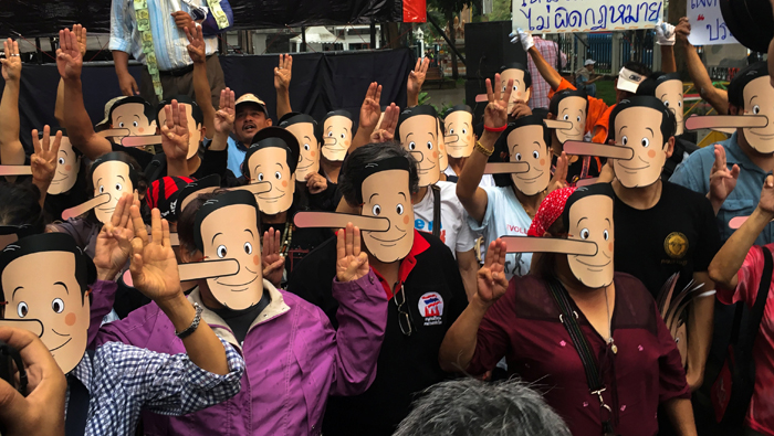 Thai activists in Pinocchio masks mock junta leader for delaying polls