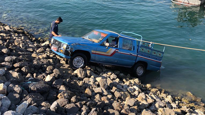 This car had to be pulled out of the sea at an Oman fishing port