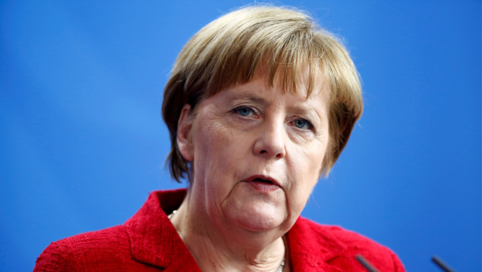 Merkel under fire from own ranks over coalition deal