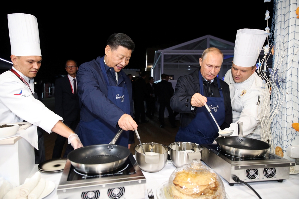 بالصور.. بوتين يعلم نظيره الصيني إعداد الفطائر الروسية
