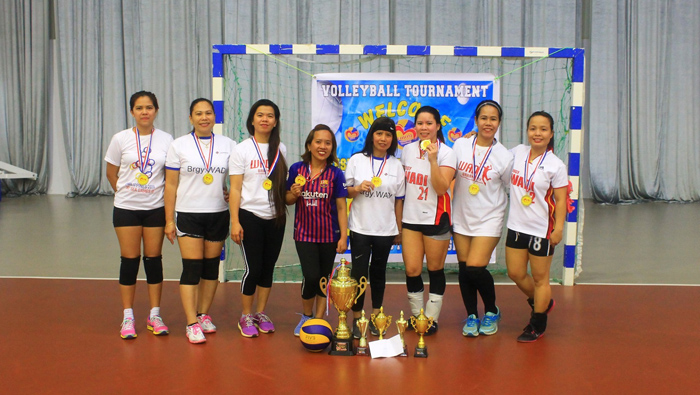 Philippine workers take part in volleyball match