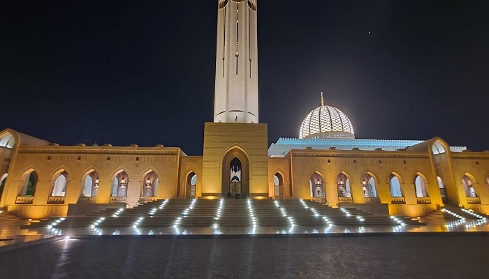 Sultan Qaboos Grand Mosque lit up in orange