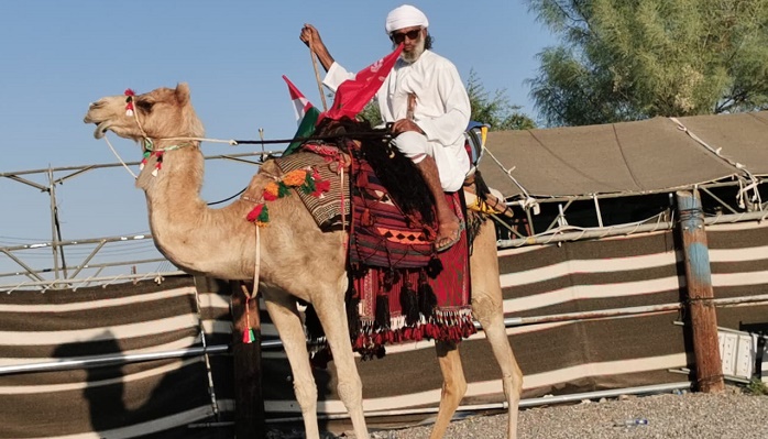 Omani travels from Adam to Muscat  on camel to show people the old ways