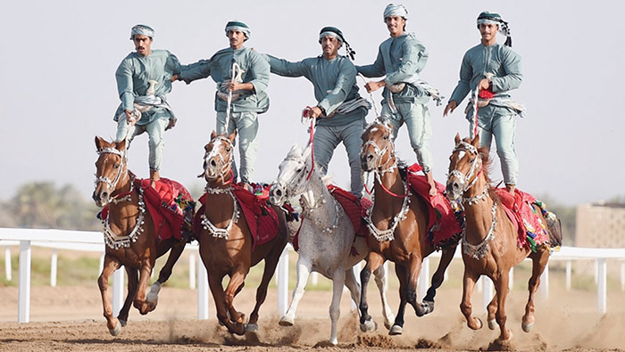 Omani jockeys perform at Al Rahba horse racecourse